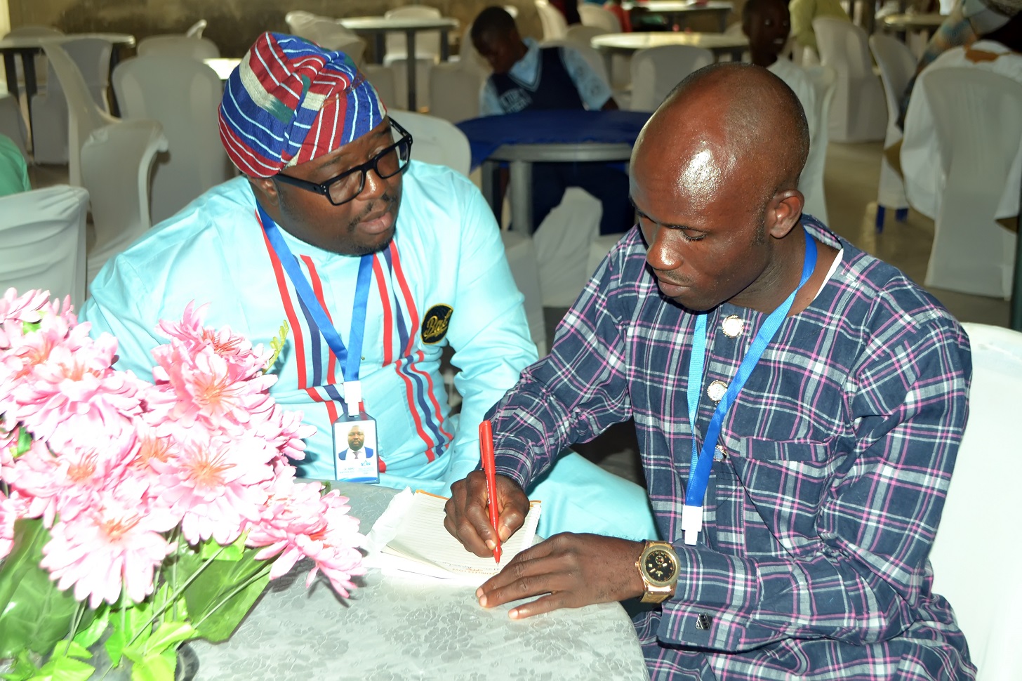 Dr. Bayo Arowolaju with a colleague recording award recipients at a BAF ceremony